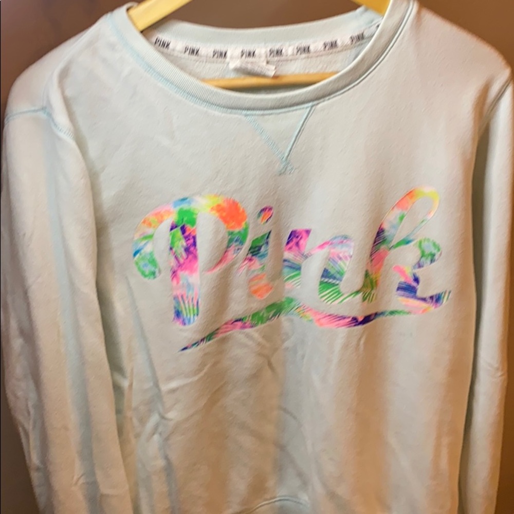 Light teal sweatshirt with tropical graphic. Pink